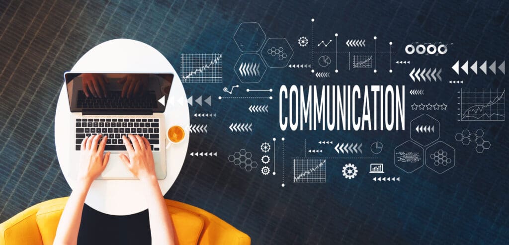 Top-down view of a person typing on a laptop at a white desk with coffee, overlaid with digital graphics and the word “Communication” representing digital marketing strategy.