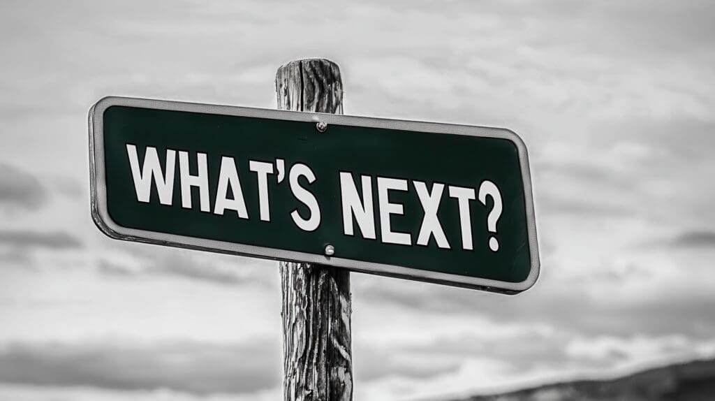 We Discover What's Next in Future-Proof Web Design Street sign reading “What’s Next?” against a cloudy sky, representing future-focused marketing strategy and innovation.