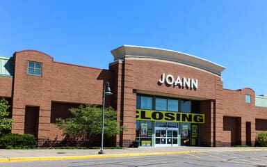 Big box retailers store closing with Joann storefront displaying large closing sign