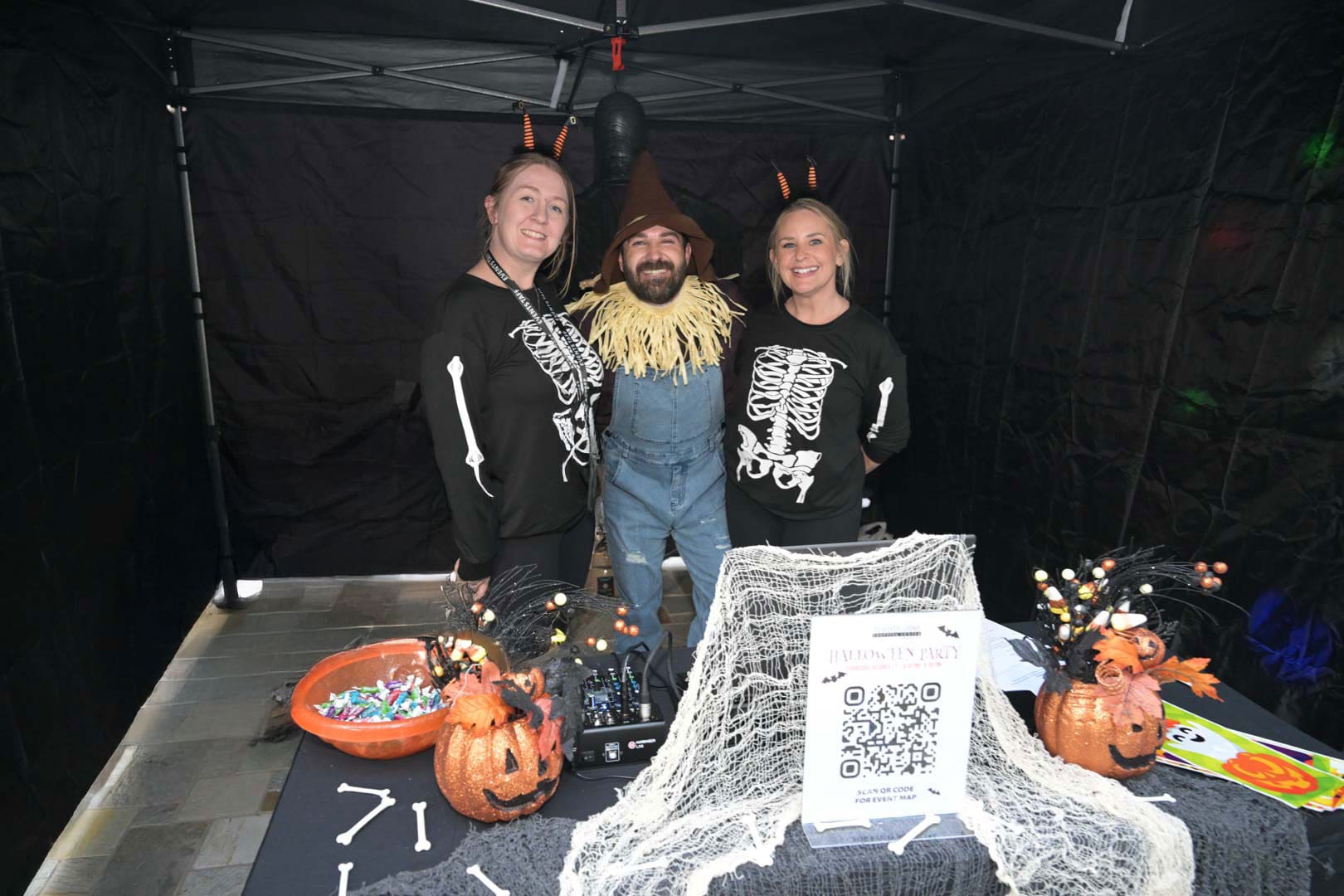 Halloween marketing community event with staff in costumes handing out candy