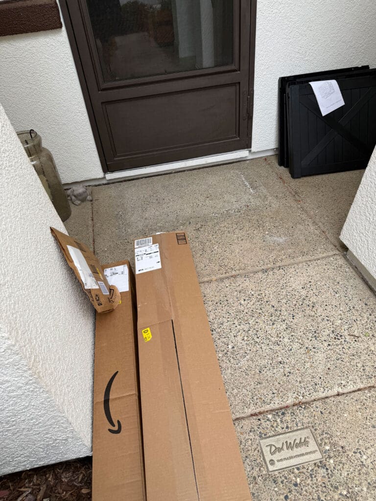 The Battle Between Local Retail and Online Shopping Giants Amazon delivery boxes on a porch highlighting the shift between local retail and online shopping