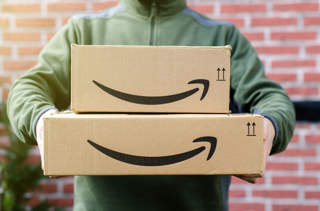 Why Retail Isn’t the Same as 15 Years Ago: The Amazon Effect on Retail Person holding Amazon boxes representing the Amazon effect on retail and modern shopping habits.