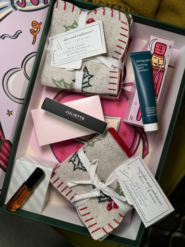 Eco friendly holiday gift box with dish towels, beauty minis, and sustainable self care items used to illustrate sustainable holiday marketing trends.